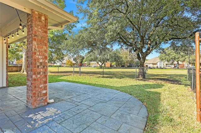 a view of a yard with large trees