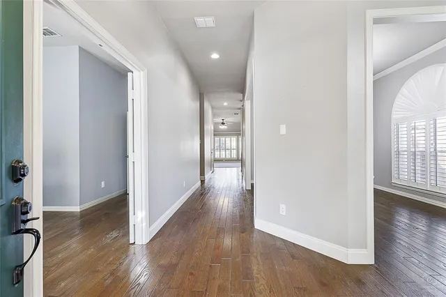 a view of hallway with wooden floor