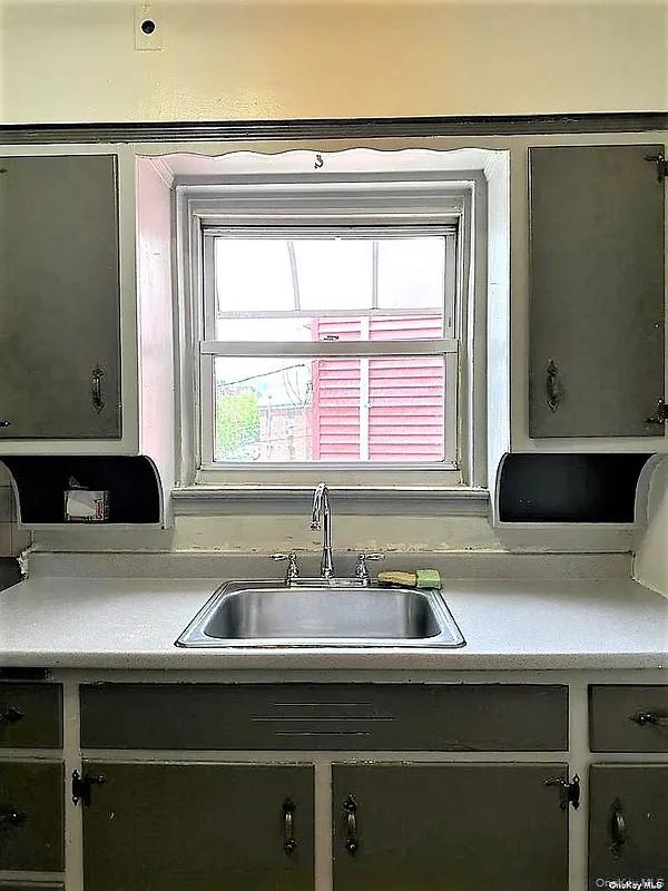 47-05 Newtown Road Queens, NY 11103 - Photo 13 of 21 a kitchen with a sink and a window