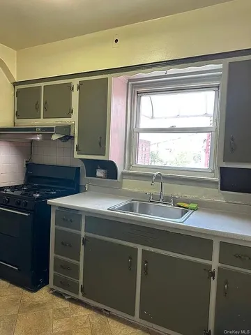 a kitchen with a sink and a stove