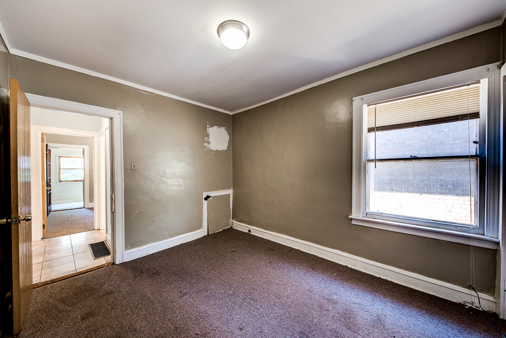 8024 South Perry Avenue Chicago, IL 60620 - Photo 14 of 37 an empty room with a empty space and windows