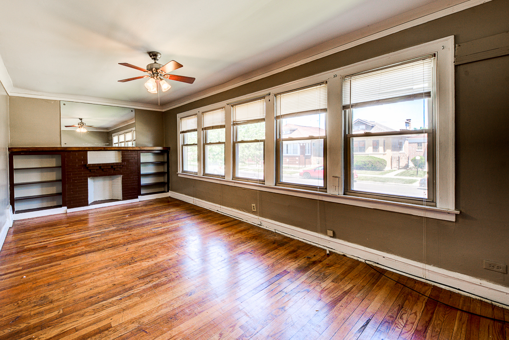 8024 South Perry Avenue Chicago, IL 60620 - Photo 17 of 37 a view of an empty room with a window and wooden floor