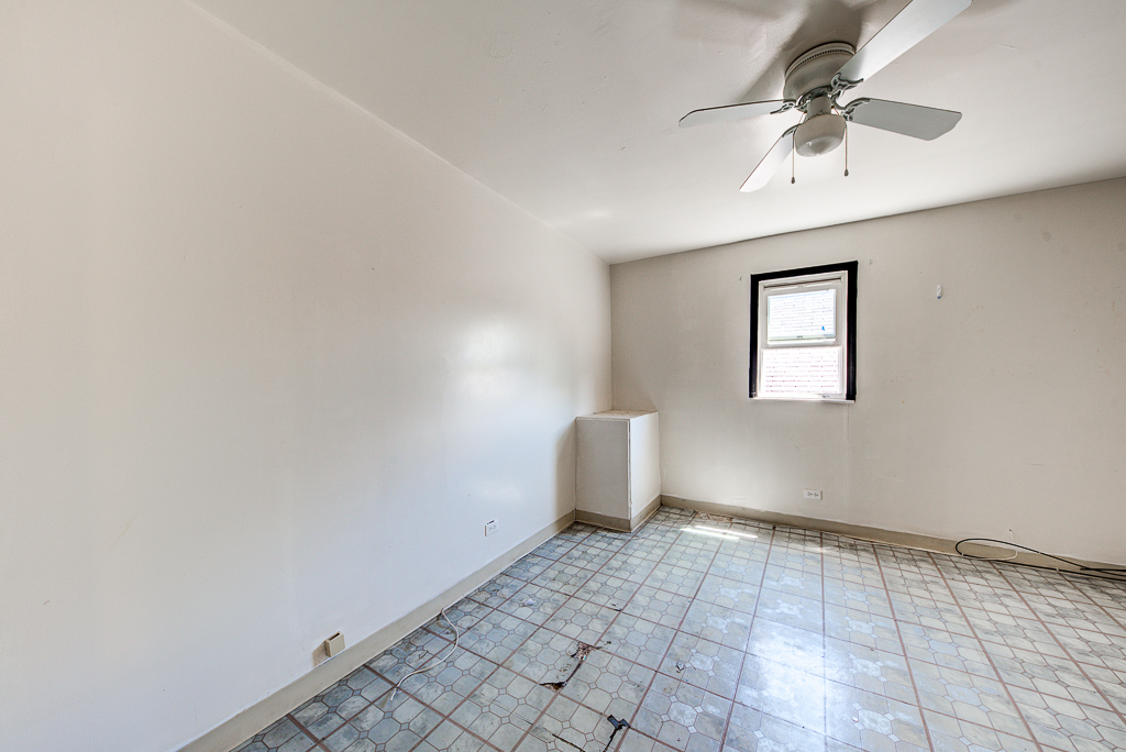 8024 South Perry Avenue Chicago, IL 60620 - Photo 20 of 37 a view of a livingroom with a chandelier fan and windows