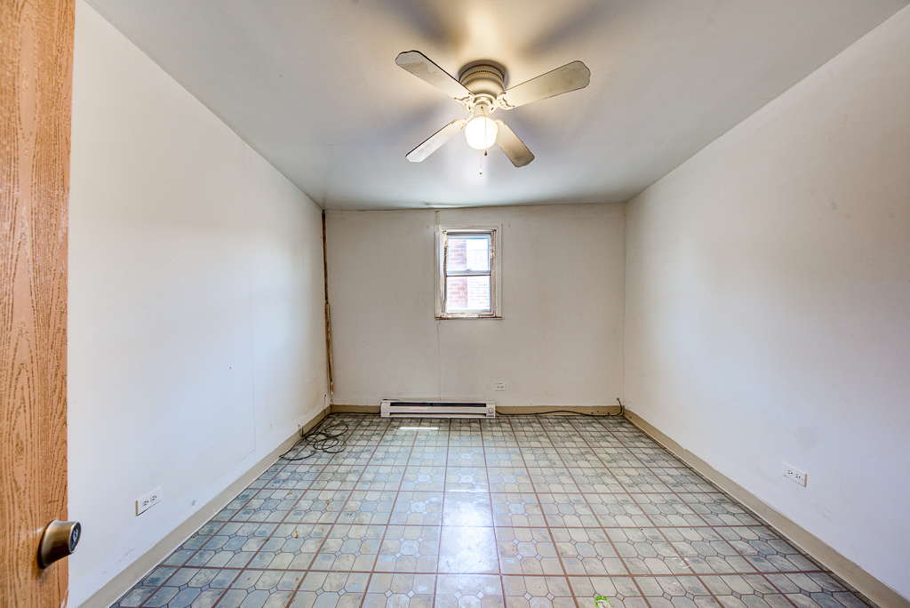 8024 South Perry Avenue Chicago, IL 60620 - Photo 22 of 37 an empty room with windows and fan