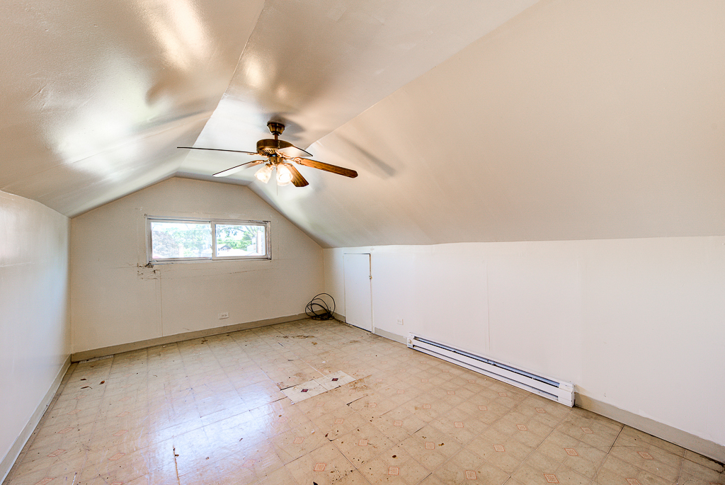 8024 South Perry Avenue Chicago, IL 60620 - Photo 24 of 37 an empty room with a ceiling fan and window