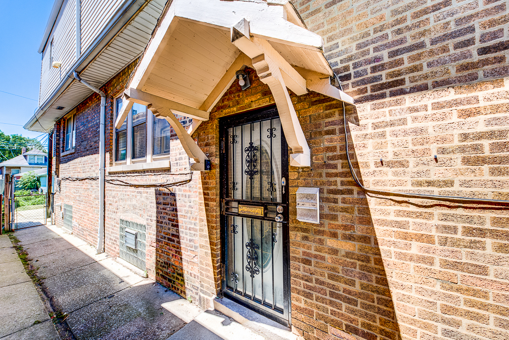 8024 South Perry Avenue Chicago, IL 60620 - Photo 4 of 37 a view of a brick house with many windows