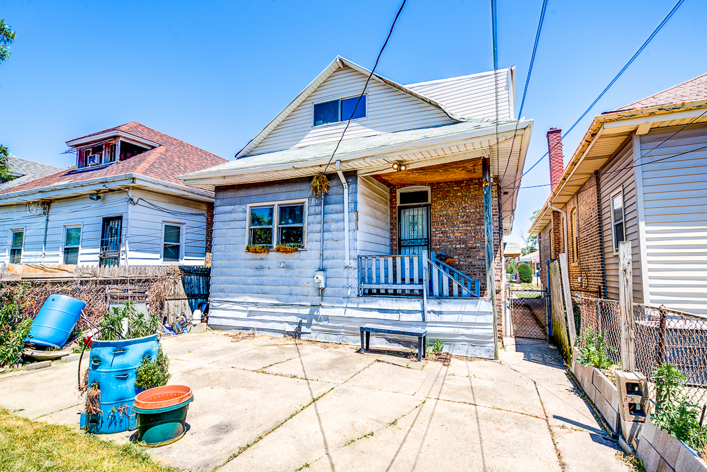 8024 South Perry Avenue Chicago, IL 60620 - Photo 33 of 37 a front view of a house with patio