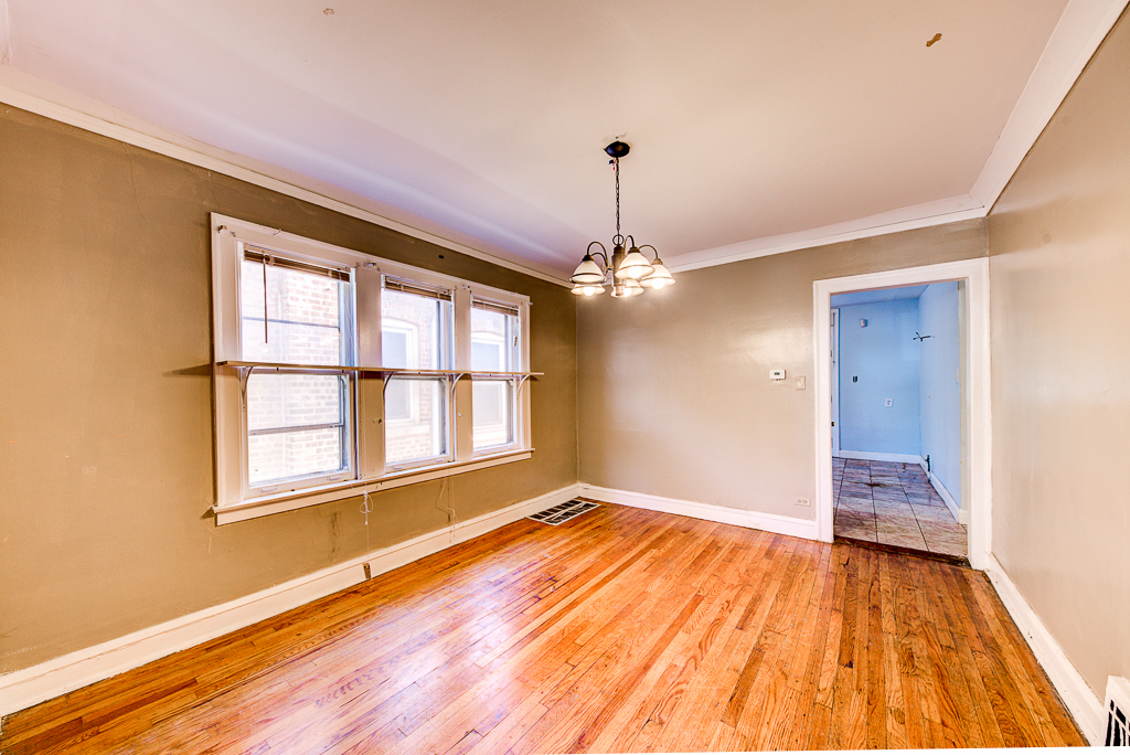 8024 South Perry Avenue Chicago, IL 60620 - Photo 5 of 37 a view of empty room with wooden floor and fan