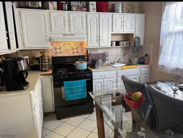 a kitchen with stainless steel appliances granite countertop a stove a sink a refrigerator and cabinets