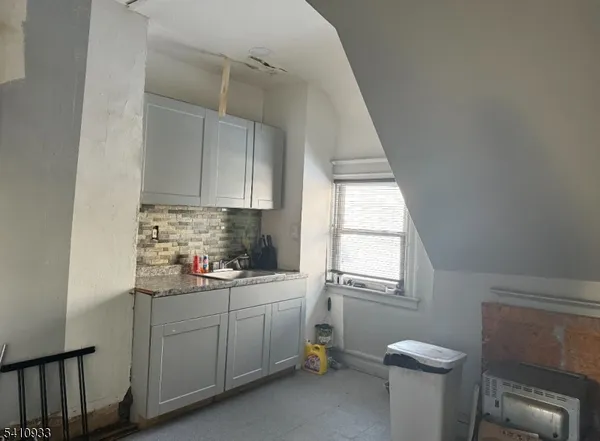 a kitchen with a sink cabinets appliances and a window