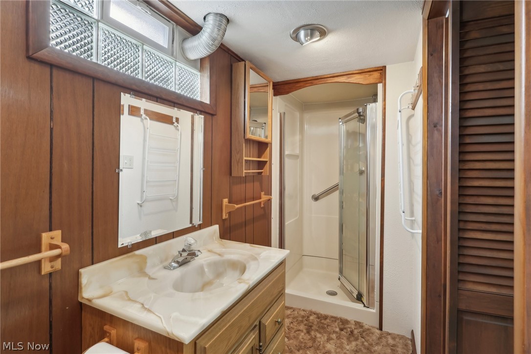 3873 Baumberger Road Stow, OH 44224 - Photo 40 of 50 Bathroom with vanity with extensive cabinet space and an enclosed shower