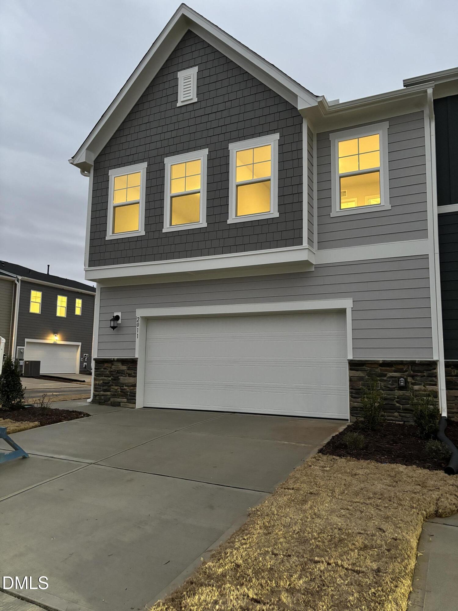 a front view of a house with a garage