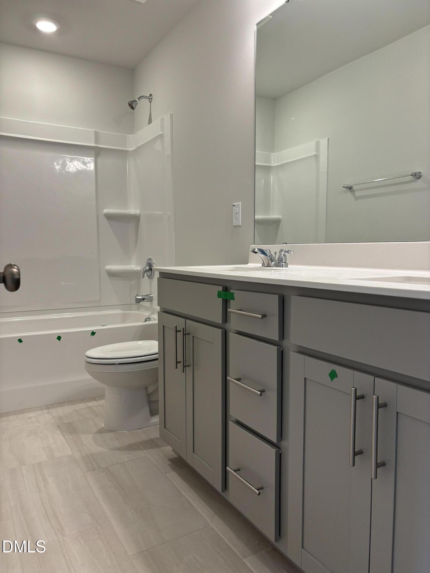 2011 Rabbit Hop Trail Apex, NC 27502 - Photo 17 of 27 a bathroom with a granite countertop sink mirror and toilet