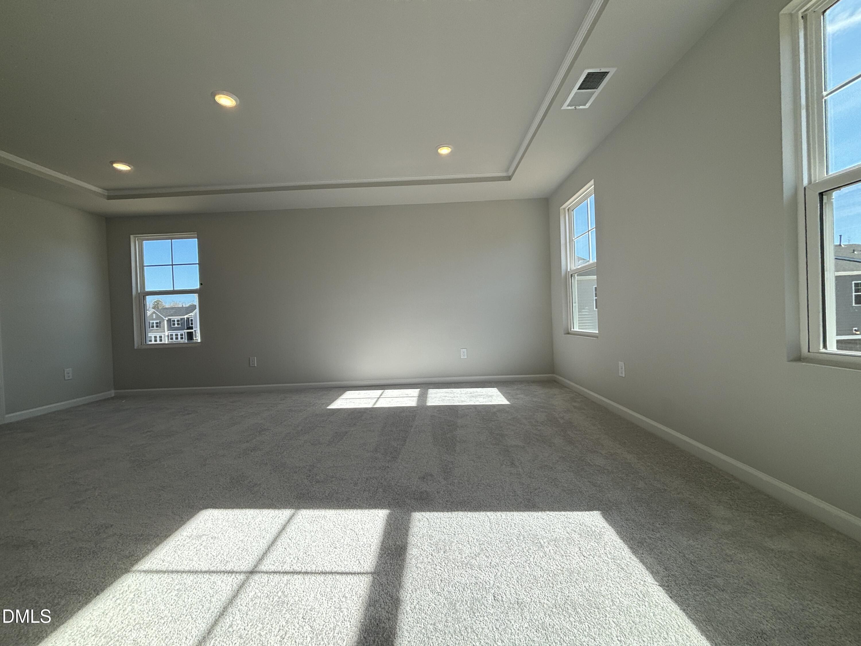 2011 Rabbit Hop Trail Apex, NC 27502 - Photo 25 of 27 an empty room with windows and chandelier fan