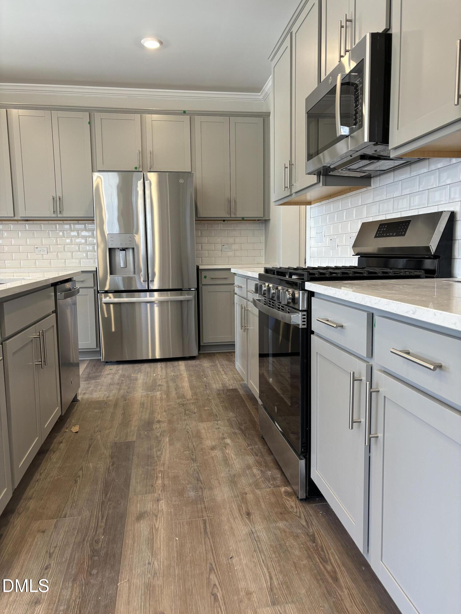 2011 Rabbit Hop Trail Apex, NC 27502 - Photo 5 of 27 a kitchen with cabinets stainless steel appliances and wooden floor