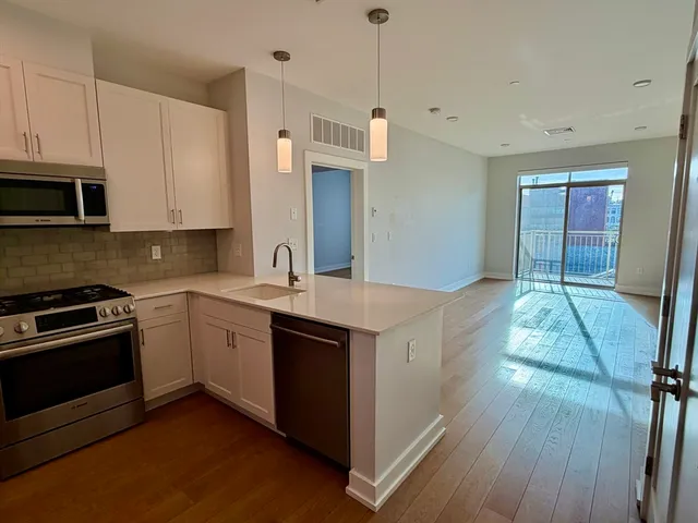 a kitchen with stainless steel appliances granite countertop a stove and a sink