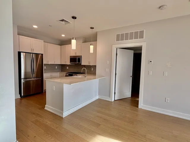 a kitchen with stainless steel appliances a refrigerator stove microwave and cabinets