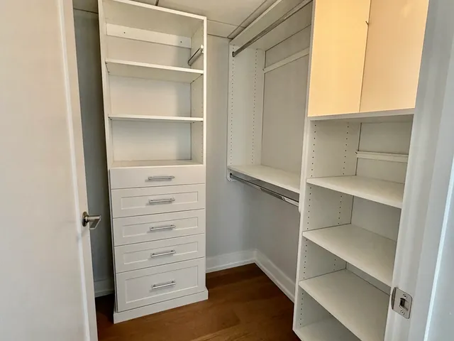 a view of walk in closet with empty racks