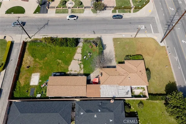 an aerial view of a house with a yard
