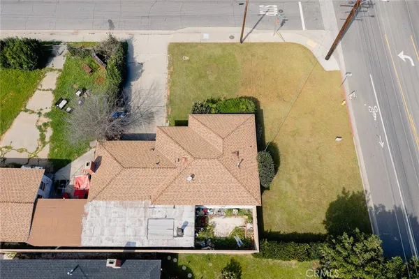 an aerial view of a house with a yard
