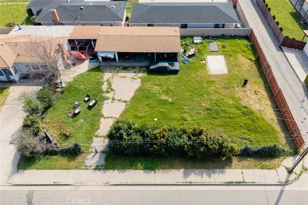 an aerial view of residential houses with yard