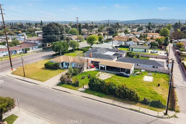 an aerial view of a house with a garden and swimming pool