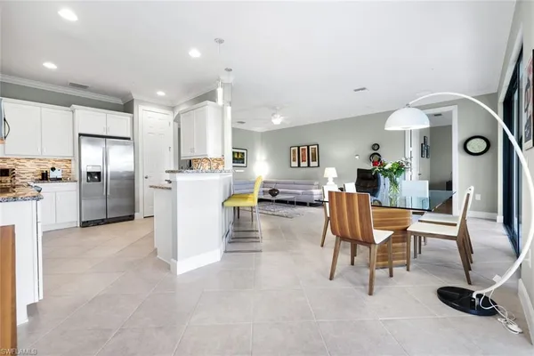 a living room with furniture and kitchen view