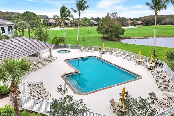 an aerial view of a house with swimming pool and a yard