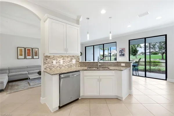 a kitchen with granite countertop a sink and a stove