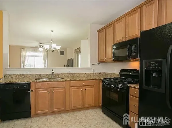 a kitchen with a sink stove and microwave