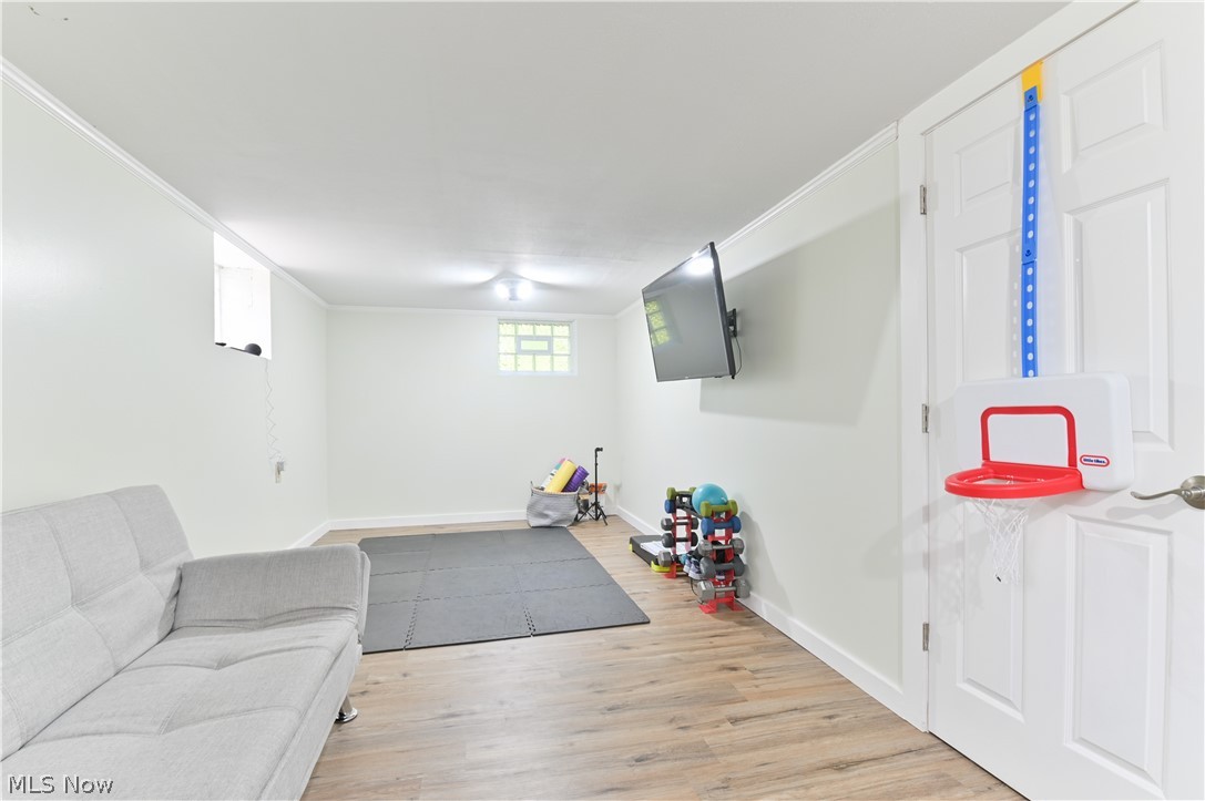 2725 Rockefeller Road Willoughby Hills, OH 44092 - Photo 14 of 21 Exercise area with ornamental molding and light hardwood / wood-style flooring