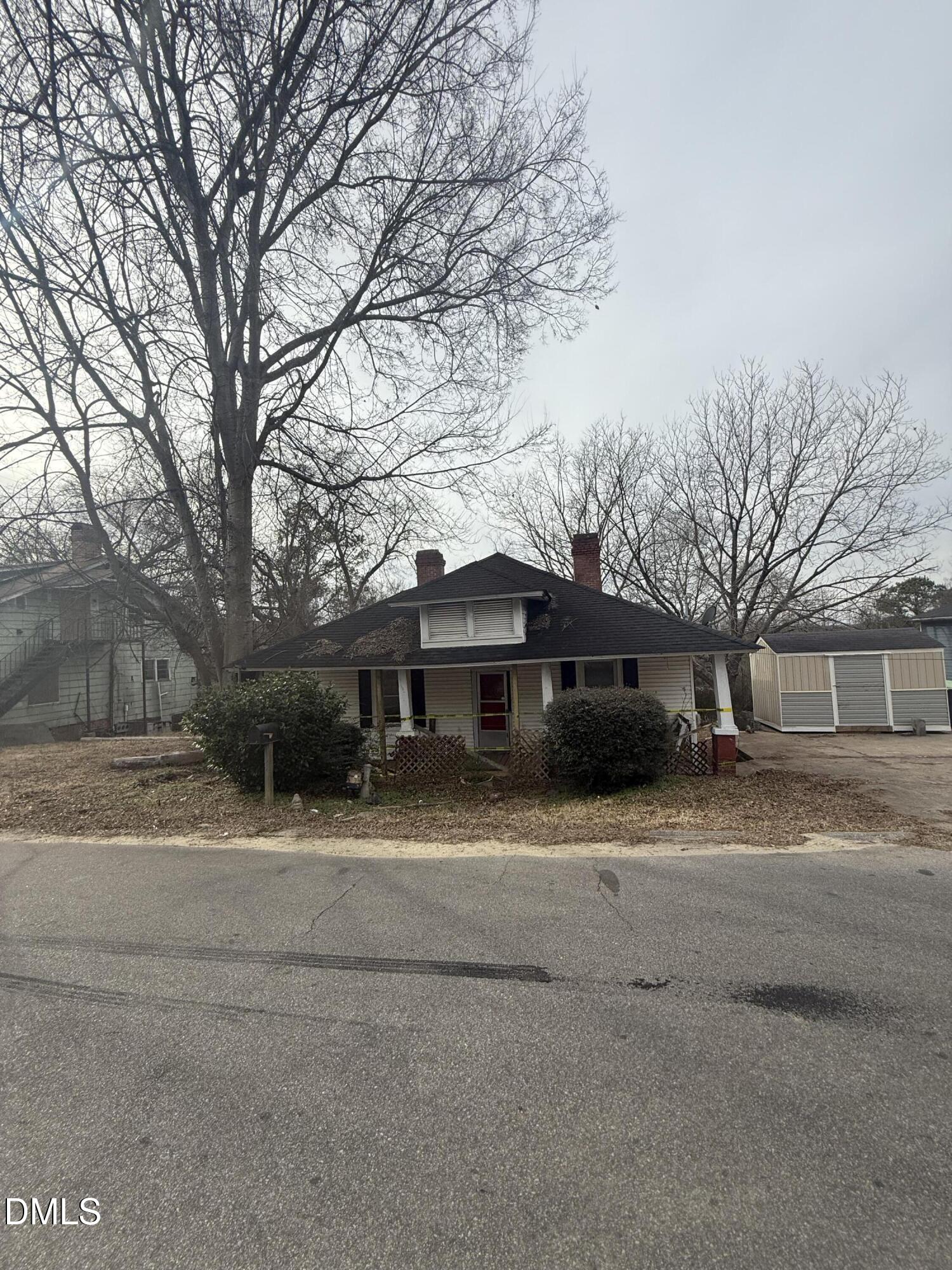 a house that has a tree in front of it