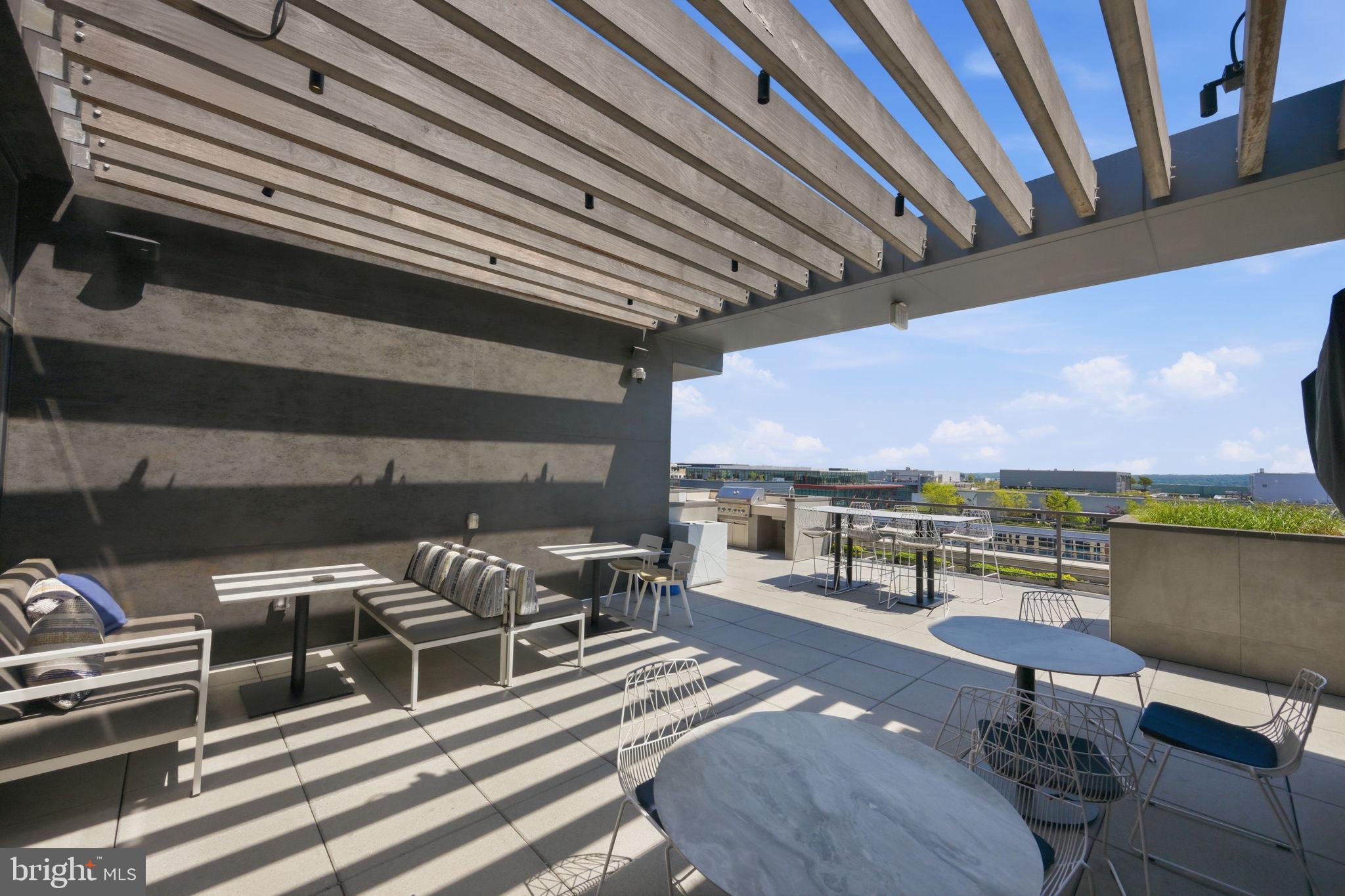 1211 Van Street Southeast, Unit 1007 Washington, DC 20003 - Photo 17 of 21 a roof deck with outdoor seating and city view