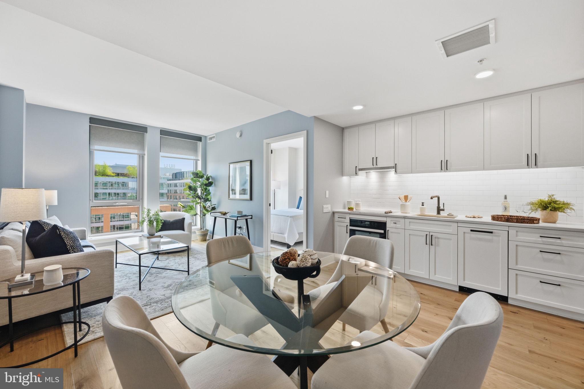 1211 Van Street Southeast, Unit 1007 Washington, DC 20003 - Photo 4 of 21 a living room with kitchen island furniture and a kitchen view