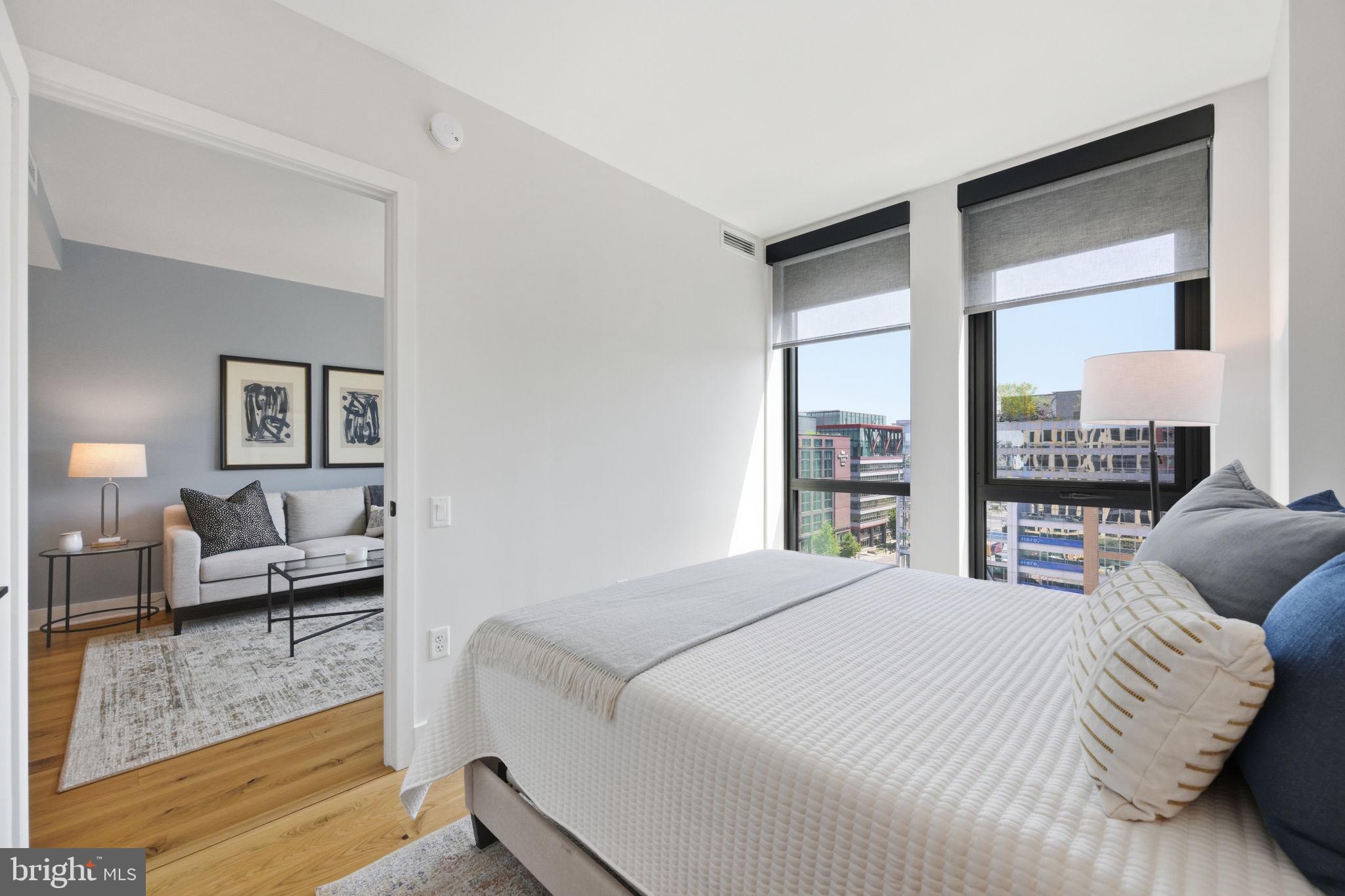 1211 Van Street Southeast, Unit 1007 Washington, DC 20003 - Photo 10 of 21 a bedroom with a bed and a couch