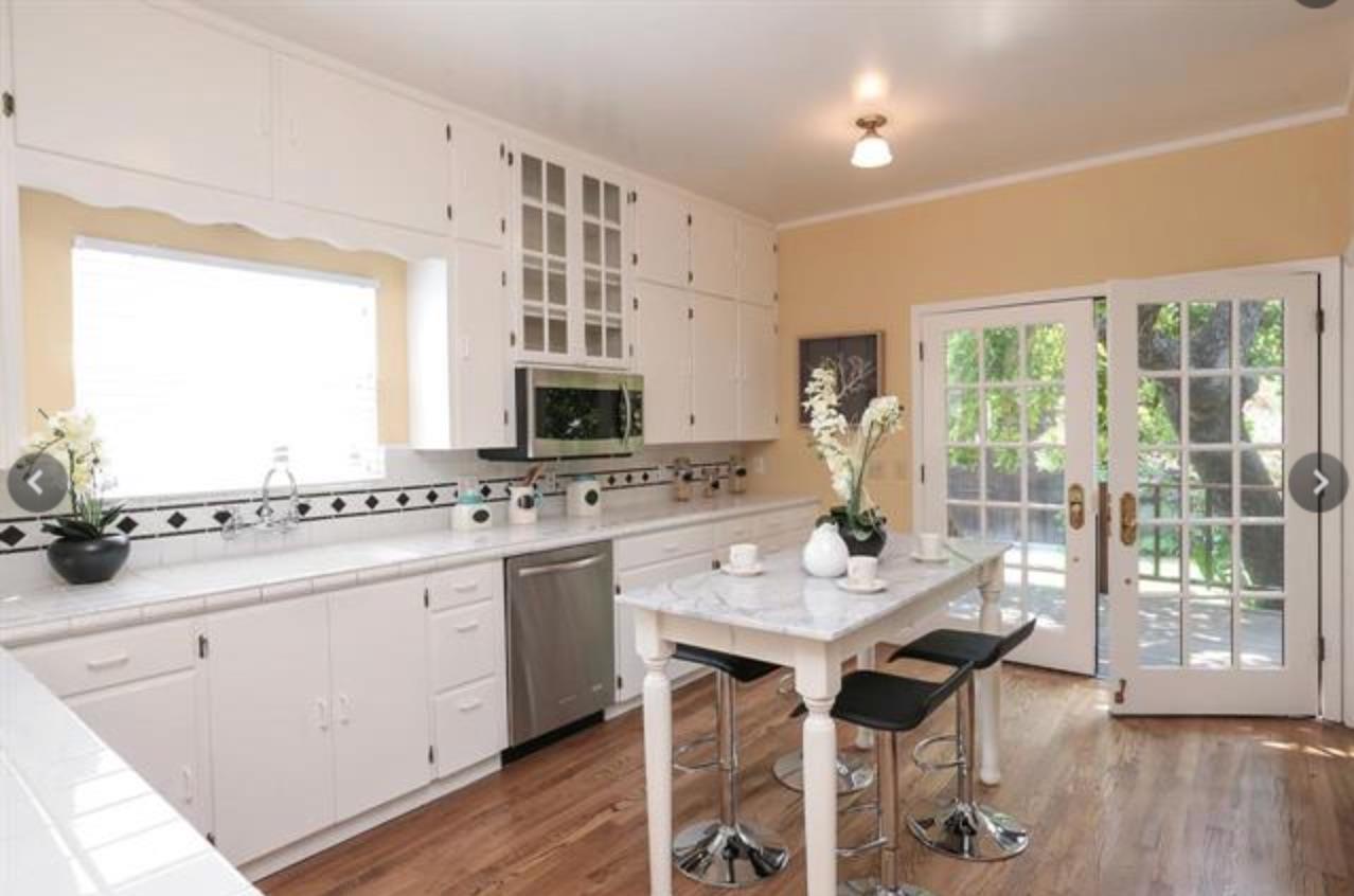 340 Kipling Street Palo Alto, CA 94301 - Photo 2 of 8 a kitchen with a table chairs stove and cabinets