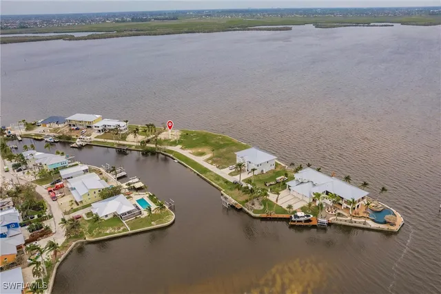 an aerial view of a house with a lake view