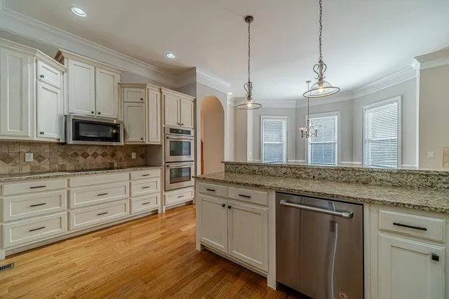 a view of empty room with wooden floor and fireplace