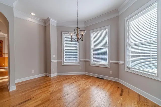 a view of hallway with closet and wooden floor