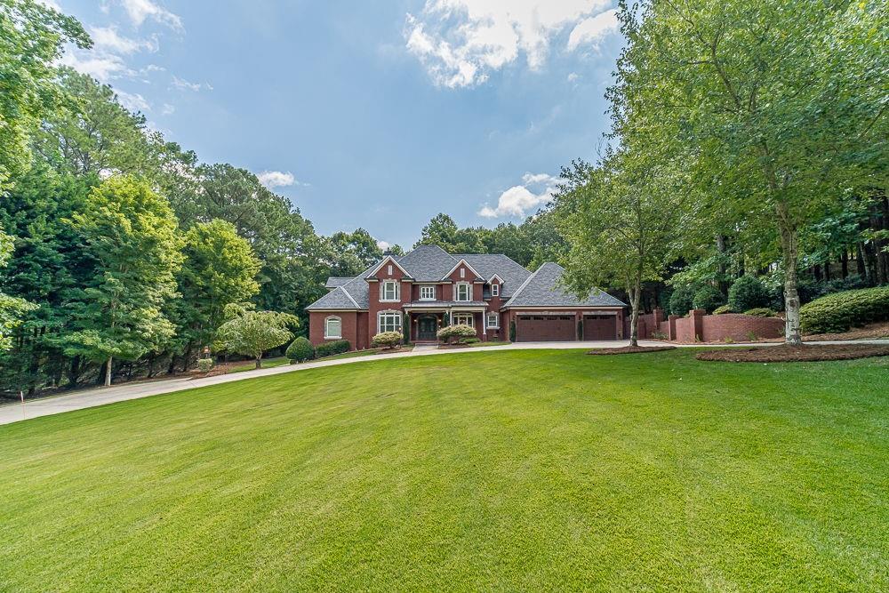 2431 Rabbit Farm Circle Loganville, GA 30052 - Photo 2 of 65 a front view of a house with garden