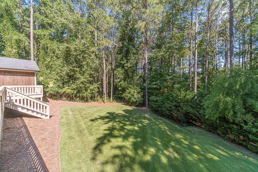 2431 Rabbit Farm Circle Loganville, GA 30052 - Photo 23 of 65 a view of a yard with plants and trees