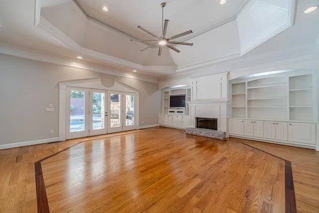 a view of an empty room with closet and a window