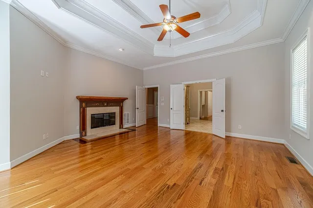 a view of a big house with a big yard and large tree