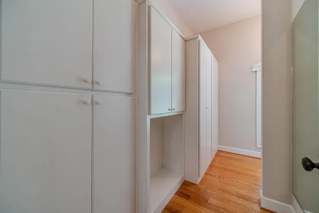 a view of a house with a yard and large tree