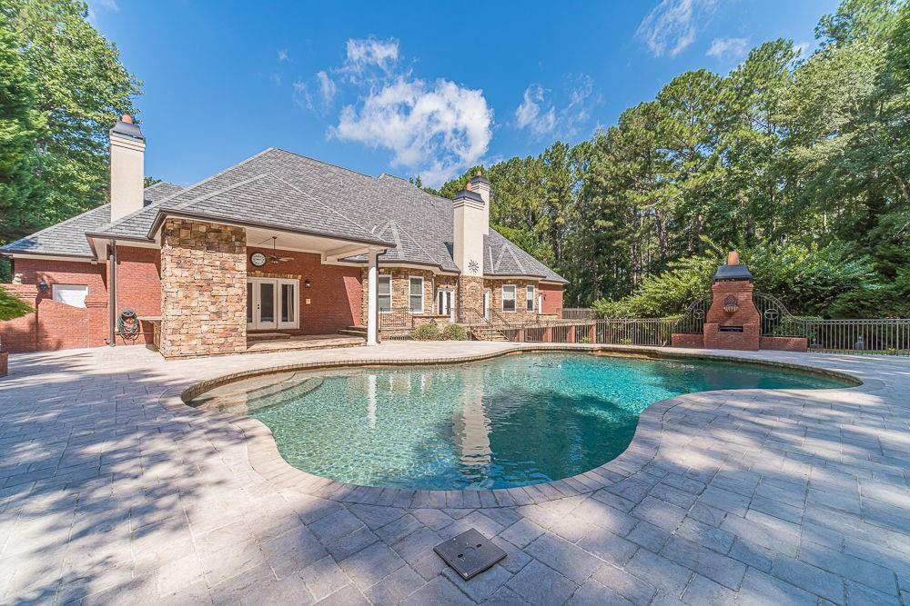 2431 Rabbit Farm Circle Loganville, GA 30052 - Photo 46 of 65 a view of a house with a swimming pool
