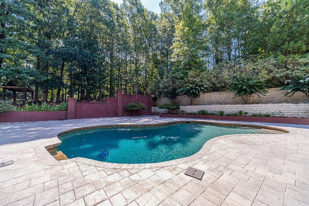 2431 Rabbit Farm Circle Loganville, GA 30052 - Photo 48 of 65 a view of a swimming pool with a yard