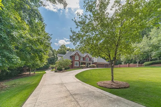 a kitchen with stainless steel appliances granite countertop a sink a stove and a wooden floors