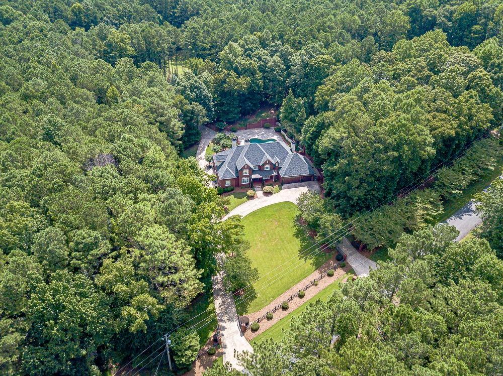 2431 Rabbit Farm Circle Loganville, GA 30052 - Photo 59 of 65 an aerial view of a house with a yard swimming pool and seating