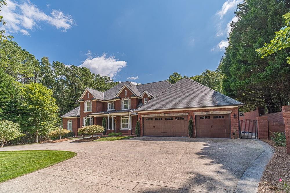 2431 Rabbit Farm Circle Loganville, GA 30052 - Photo 6 of 65 a front view of a house with a yard and garage