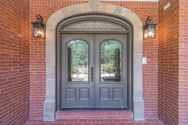a view of an empty room with a fireplace and a ceiling fan